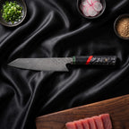 Enji 9-Piece Knife Set · Kiritsuke Chef-Slicer Knife on the cutting board