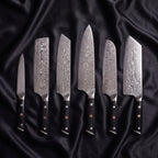 Homura Damascus Knife Set · the full set on black silk
