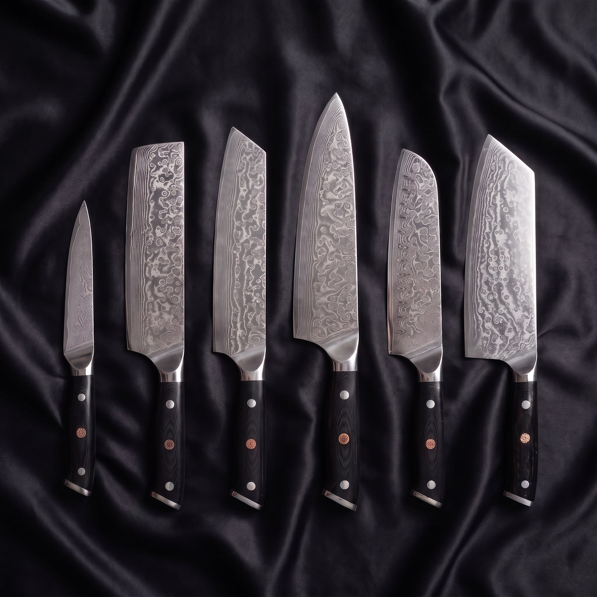 Homura Damascus Knife Set · the full set on black silk