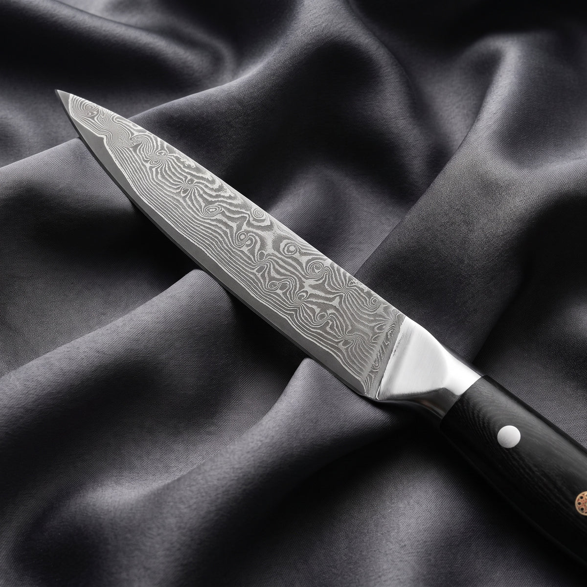 Homura Petty Utility Knife · Damascus blade close-up