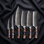 Hyoga Damascus Knife Set · the full set on black silk