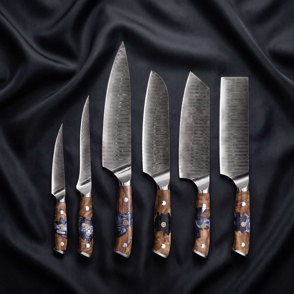 Hyoga Damascus Knife Set · the full set on black silk