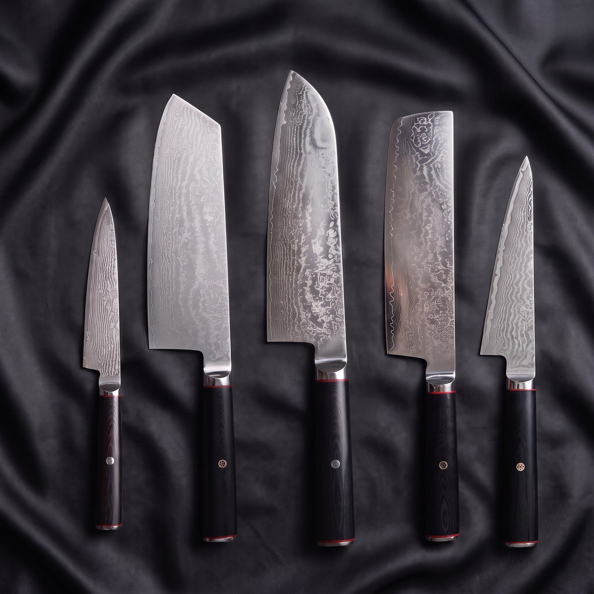 Tsurugi Damascus Knife Set · the full set on black silk