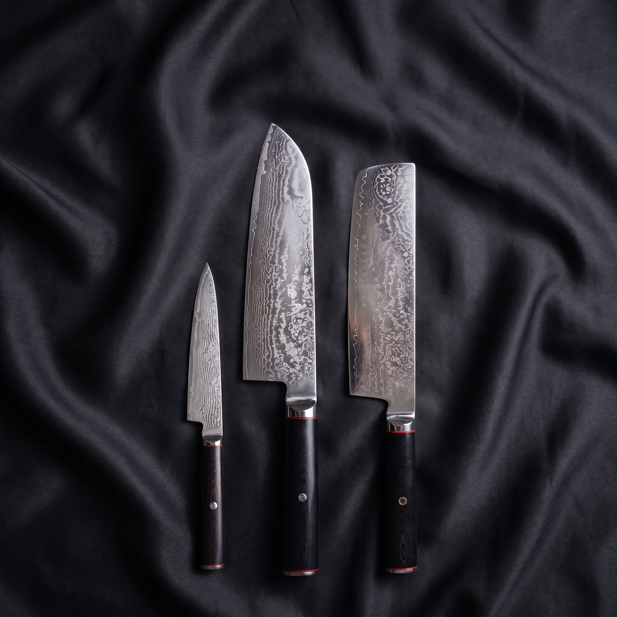 Tsurugi Knife Trio (Santoku, Nakiri & Petty) · the full set on black silk